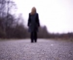 woman-gray-blur Woman walking away